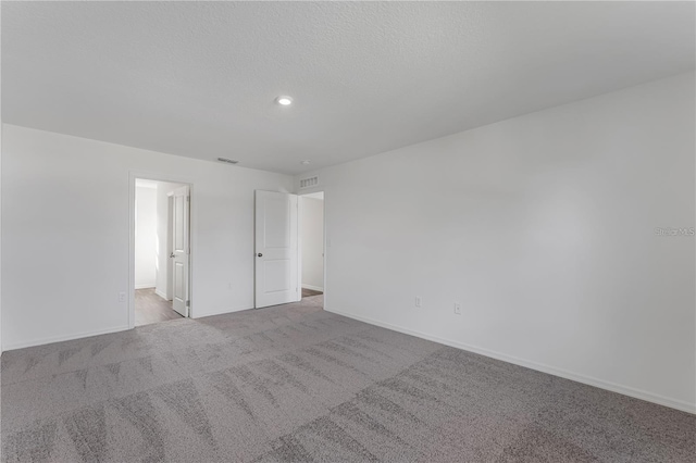 1032 Cannock Dr, Kissimmee, FL 34758 - unfurnished room with baseboards, a textured ceiling, visible vents, and carpet