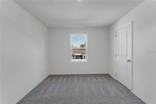 1032 Cannock Dr, Kissimmee, FL 34758 - carpeted empty room with baseboards and a textured ceiling