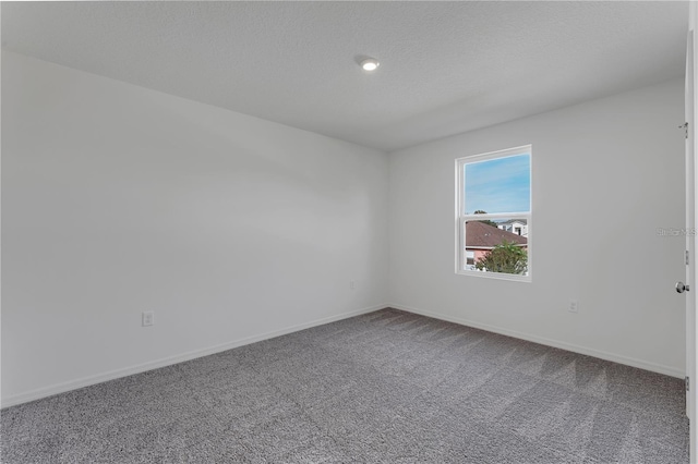 1032 Cannock Dr, Kissimmee, FL 34758 - unfurnished room featuring baseboards, a textured ceiling, and carpet