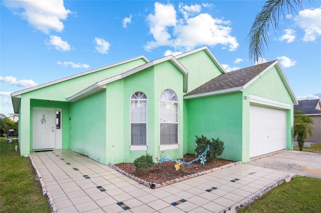 202 Aylesbury Ln, Davenport, FL 33837 - ranch-style house with a shingled roof, stucco siding, an attached garage, and driveway