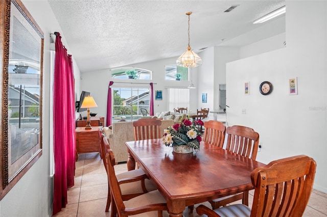 202 Aylesbury Ln, Davenport, FL 33837 - dining area with visible vents, a textured ceiling, light tile patterned floors, a notable chandelier, and vaulted ceiling