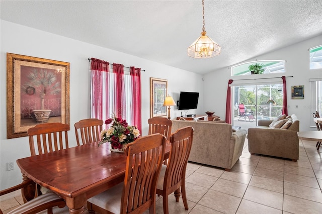 202 Aylesbury Ln, Davenport, FL 33837 - dining room featuring light tile patterned floors, a notable chandelier, a textured ceiling, and lofted ceiling