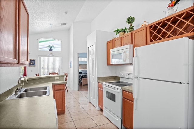 202 Aylesbury Ln, Davenport, FL 33837 - kitchen with light tile patterned flooring, a sink, white appliances, a textured ceiling, and decorative light fixtures