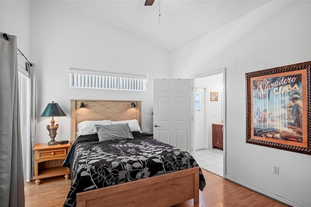 202 Aylesbury Ln, Davenport, FL 33837 - bedroom featuring high vaulted ceiling, ceiling fan, ensuite bath, and wood finished floors