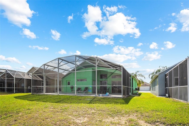 202 Aylesbury Ln, Davenport, FL 33837 - back of property with a yard and glass enclosure