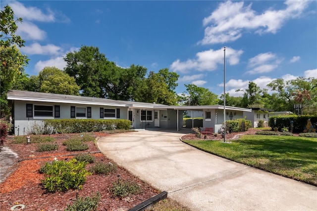 single story home featuring a front yard, stucco siding, concrete driveway, and a carport