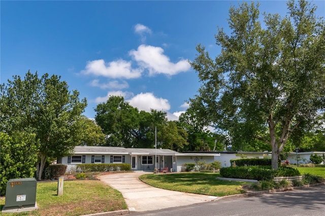 single story home featuring driveway and a front lawn