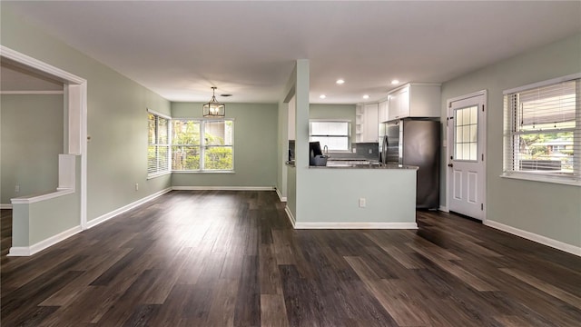 kitchen featuring baseboards, dark wood-style floors, white cabinets, and stainless steel refrigerator with ice dispenser