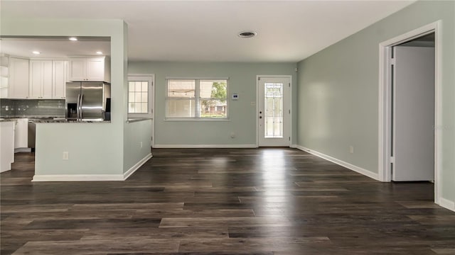 interior space featuring recessed lighting, visible vents, baseboards, and dark wood finished floors