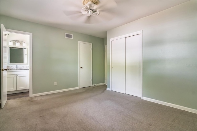 unfurnished bedroom with baseboards, carpet flooring, connected bathroom, and visible vents