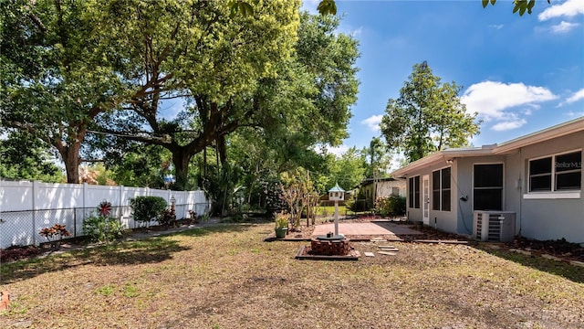 view of yard featuring a fenced backyard and central AC unit