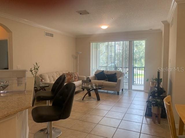 11446 Jasper Kay Ter Unit 202, Windermere, FL 34786 - living area with crown molding, light tile patterned floors, and arched walkways