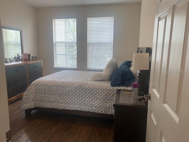 11446 Jasper Kay Ter Unit 202, Windermere, FL 34786 - bedroom featuring dark wood-style flooring and multiple windows