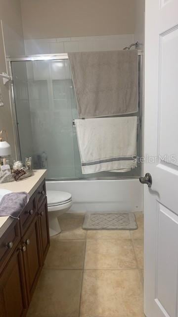 11446 Jasper Kay Ter Unit 202, Windermere, FL 34786 - bathroom featuring vanity, enclosed tub / shower combo, toilet, and tile patterned floors