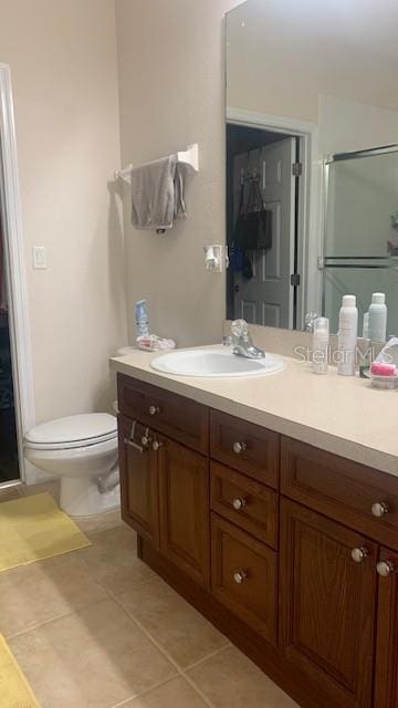 11446 Jasper Kay Ter Unit 202, Windermere, FL 34786 - bathroom featuring a stall shower, vanity, tile patterned floors, and toilet