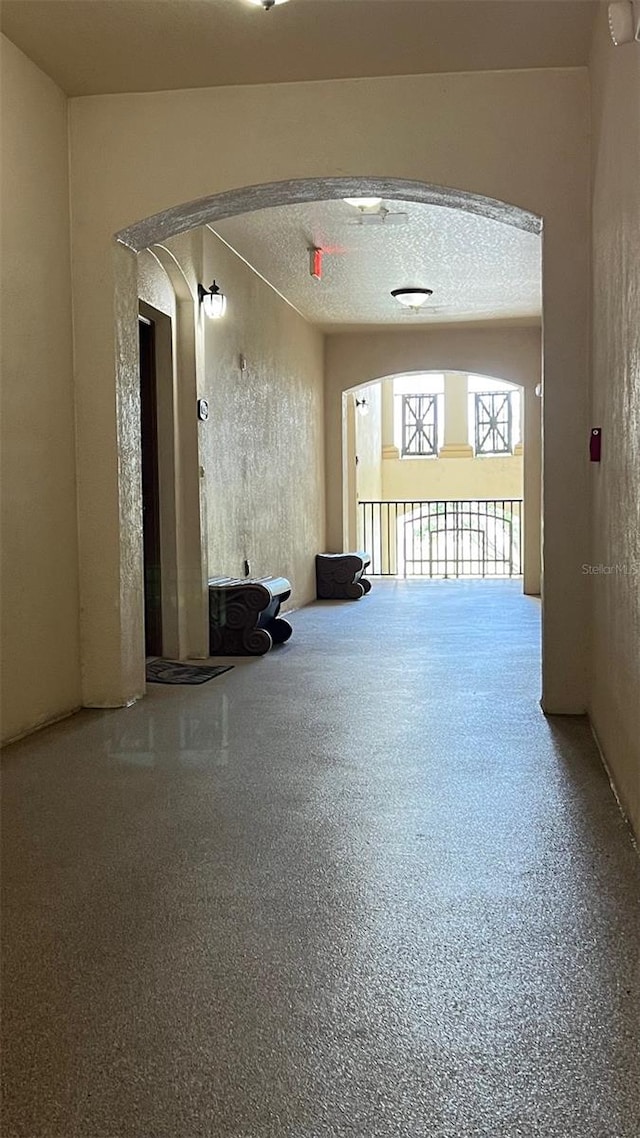 11446 Jasper Kay Ter Unit 202, Windermere, FL 34786 - unfurnished room with arched walkways and speckle patterned floor