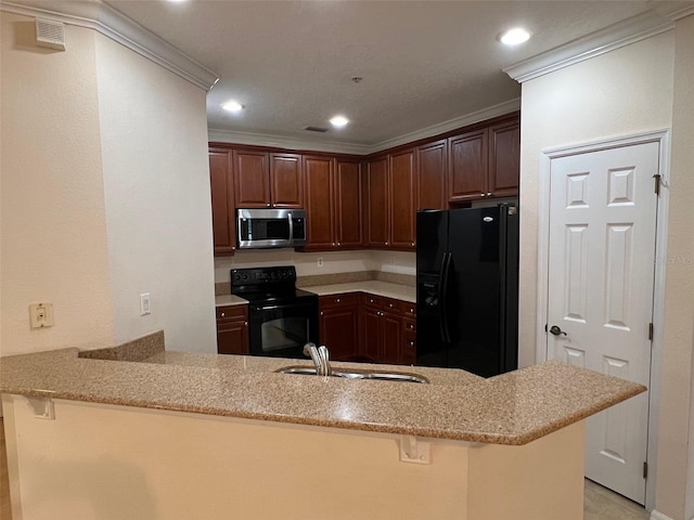 11446 Jasper Kay Ter Unit 202, Windermere, FL 34786 - kitchen featuring black appliances, crown molding, a peninsula, light stone counters, and recessed lighting