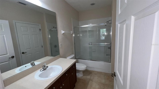 11446 Jasper Kay Ter Unit 202, Windermere, FL 34786 - full bathroom with vanity, toilet, tile patterned floors, and bath / shower combo with glass door