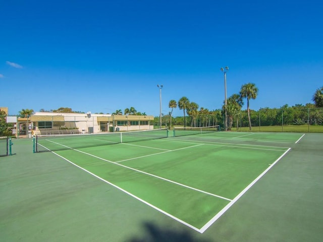 view of tennis court featuring fence