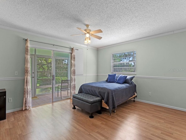 bedroom featuring access to outside, wood finished floors, crown molding, a textured ceiling, and a ceiling fan
