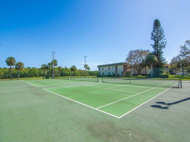 view of tennis court featuring fence