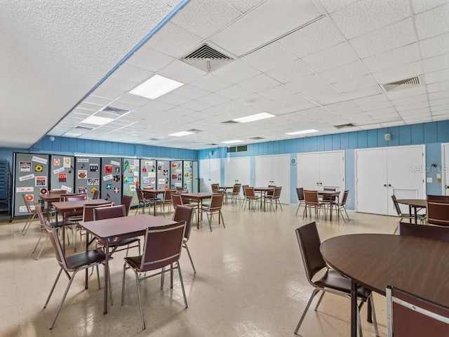 dining area featuring a drop ceiling