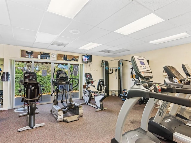 workout area with a drop ceiling and healthy amount of natural light