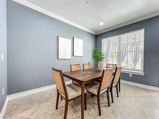 2240 Osprey Ave, Orlando, FL 32814 - dining space featuring a textured ceiling, crown molding, light tile patterned floors, and recessed lighting