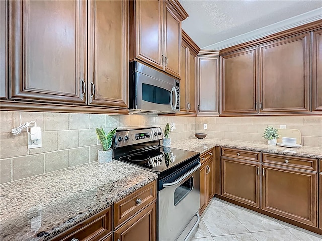 2240 Osprey Ave, Orlando, FL 32814 - kitchen featuring stainless steel appliances, light stone countertops, decorative backsplash, and light tile patterned floors