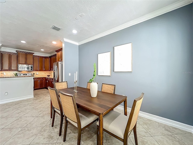 2240 Osprey Ave, Orlando, FL 32814 - dining room featuring crown molding, light tile patterned floors, recessed lighting, and a textured ceiling