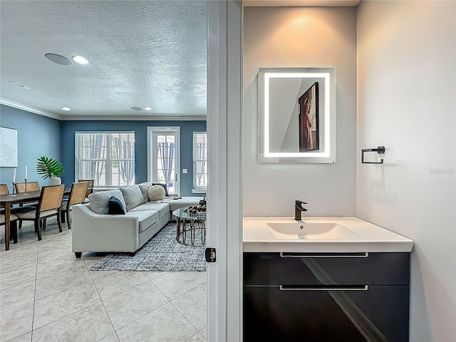 2240 Osprey Ave, Orlando, FL 32814 - living area with light tile patterned floors, crown molding, a textured ceiling, and recessed lighting