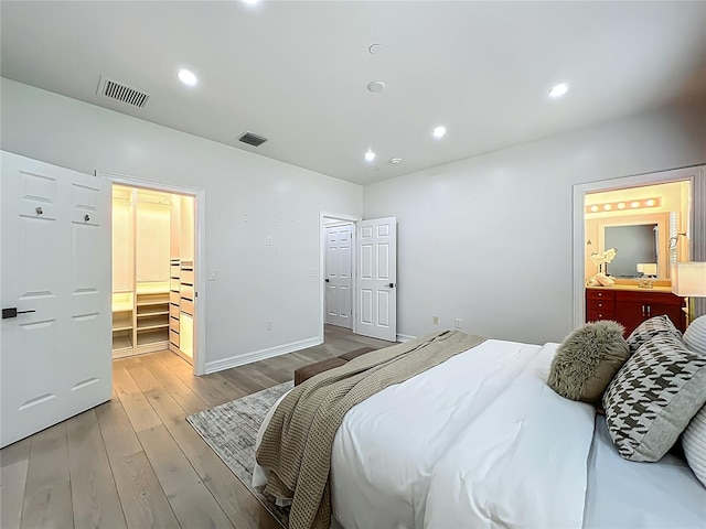 2240 Osprey Ave, Orlando, FL 32814 - bedroom with wood finished floors, connected bathroom, and recessed lighting