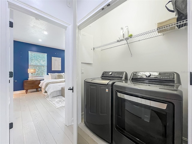 2240 Osprey Ave, Orlando, FL 32814 - laundry area featuring separate washer and dryer and light wood-style flooring