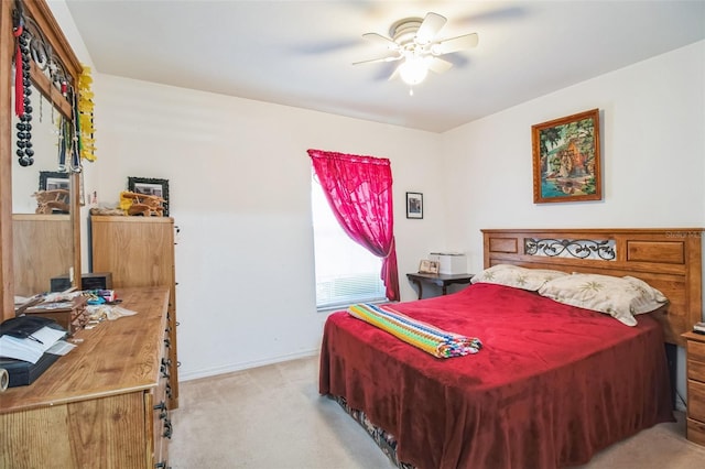 bedroom featuring baseboards, ceiling fan, and light colored carpet