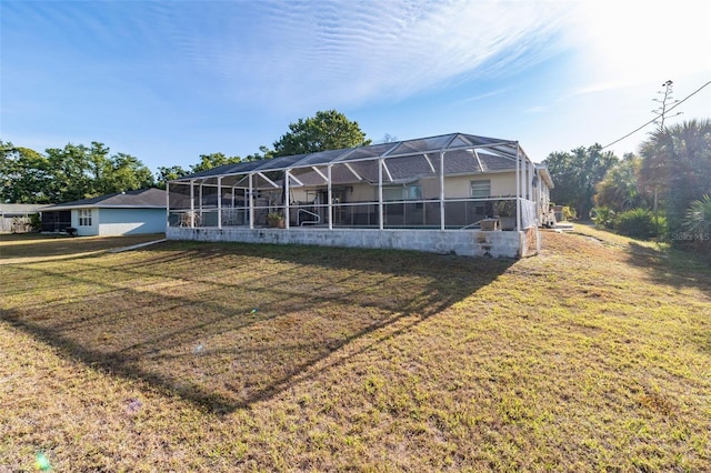 view of front facade featuring glass enclosure, a front yard, and stucco siding