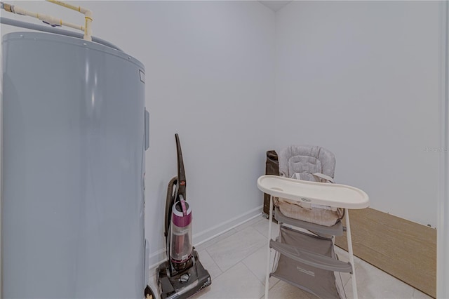 2760 Bookmark Dr, Kissimmee, FL 34746 - miscellaneous room with water heater, baseboards, and tile patterned floors