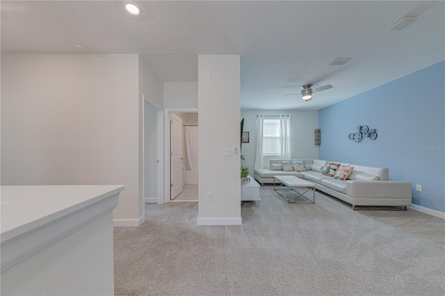 2760 Bookmark Dr, Kissimmee, FL 34746 - unfurnished living room featuring light carpet, baseboards, ceiling fan, and a textured ceiling