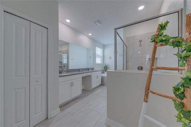2760 Bookmark Dr, Kissimmee, FL 34746 - full bathroom with a closet, a textured ceiling, recessed lighting, vanity, and tiled shower