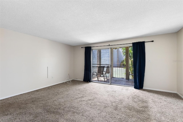 empty room with baseboards, a textured ceiling, and carpet