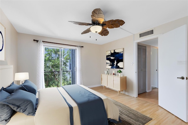 bedroom with baseboards, ceiling fan, visible vents, and light wood-style floors