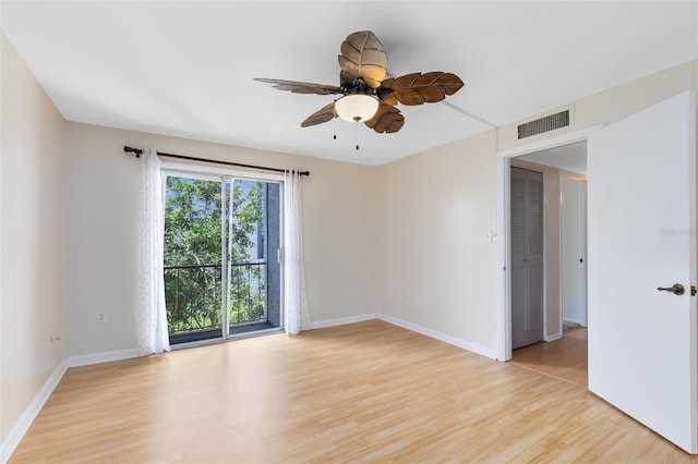 spare room with baseboards, a ceiling fan, visible vents, and light wood-type flooring