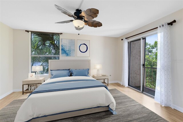 bedroom with baseboards, access to exterior, and wood finished floors