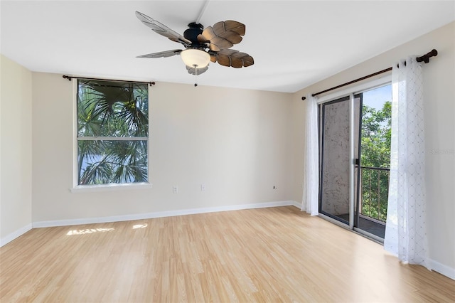 unfurnished room featuring a ceiling fan, baseboards, and wood finished floors