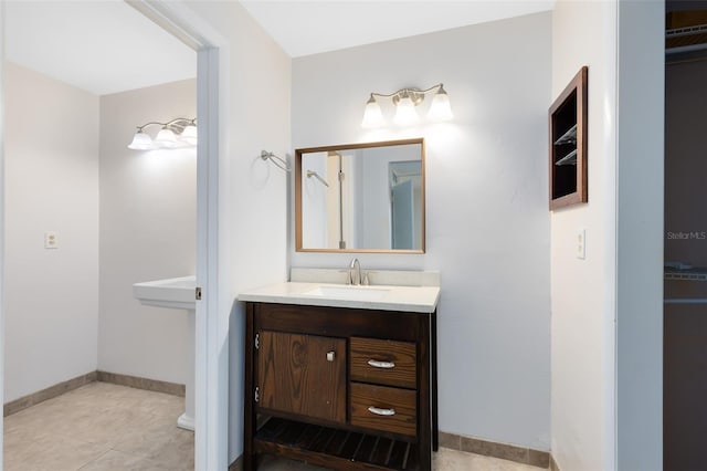 bathroom with baseboards, a sink, and tile patterned floors