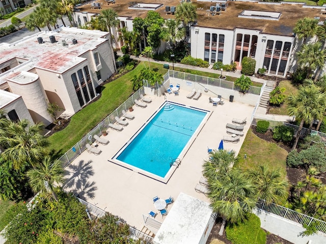 community pool featuring fence and a patio