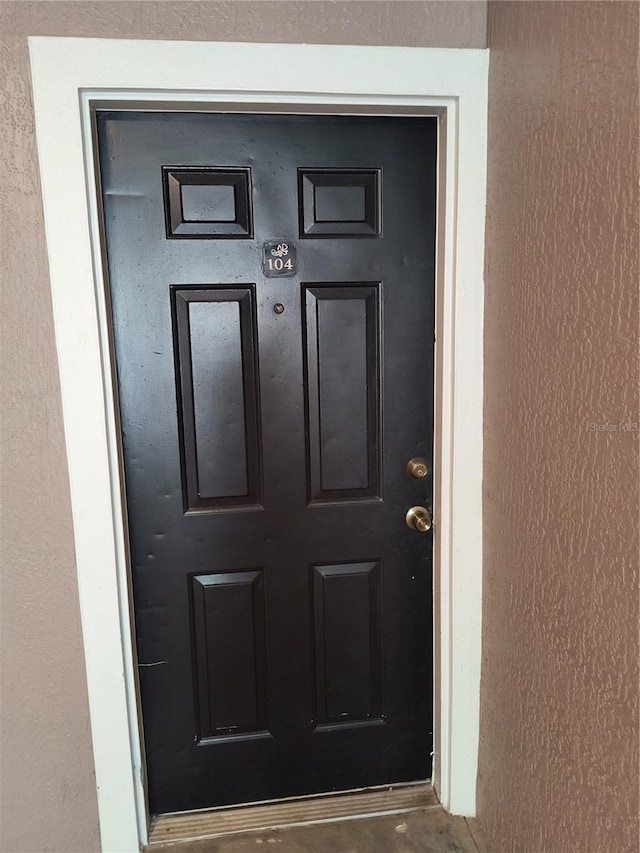 view of exterior entry featuring stucco siding