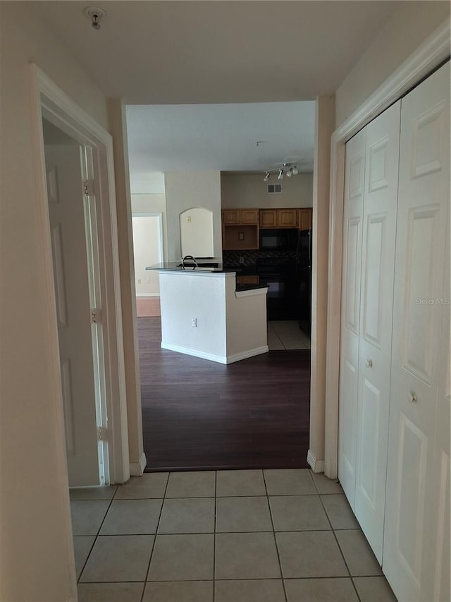 corridor featuring light tile patterned flooring