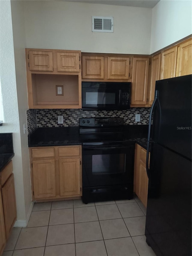 kitchen featuring decorative backsplash, dark countertops, black appliances, and visible vents