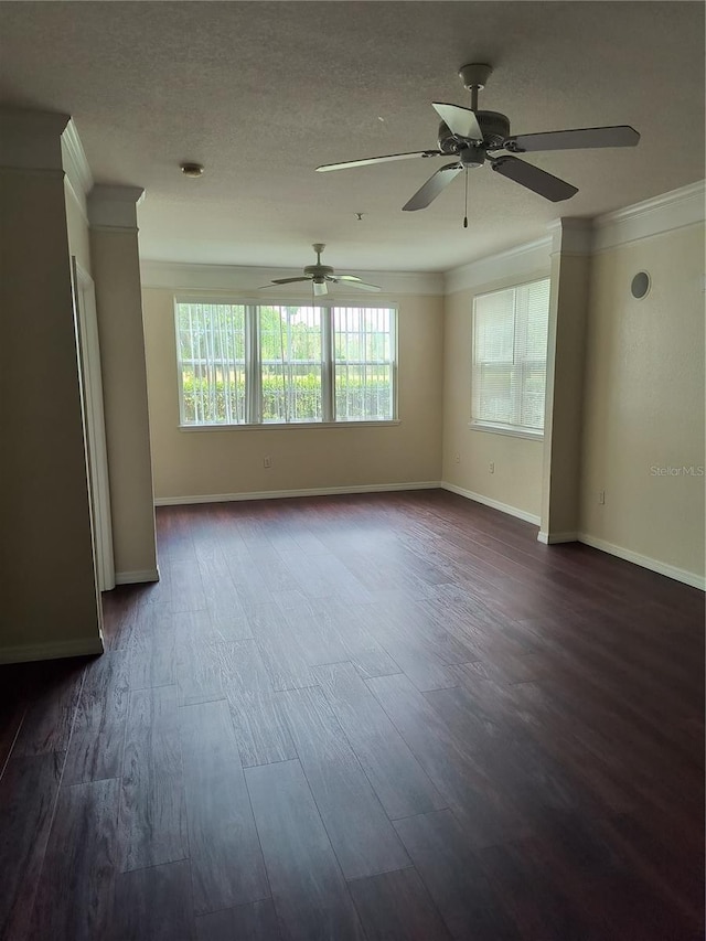 empty room with baseboards, dark wood-style floors, a ceiling fan, and crown molding