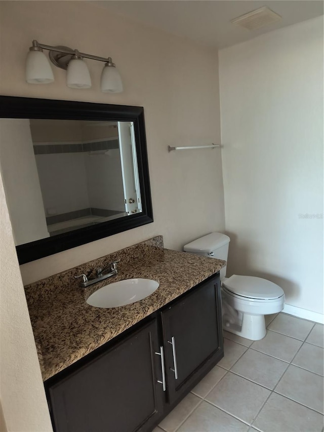 bathroom featuring visible vents, baseboards, toilet, tile patterned floors, and vanity